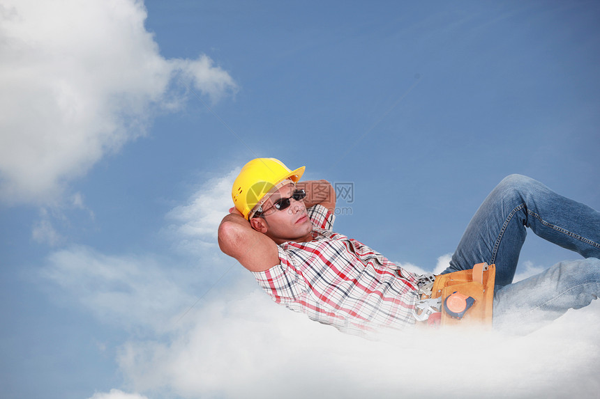 放松的工人躺在云上图片
