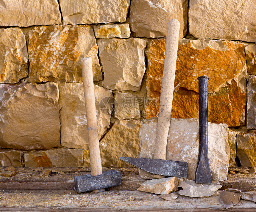 石匠泥瓦工的锤子工具工作风格房子风化建筑学石工壁垒建造栅栏石墙图片