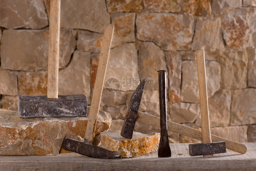 石匠泥瓦工的锤子工具建筑学风格建造栅栏壁垒建筑石头工作房子石方图片