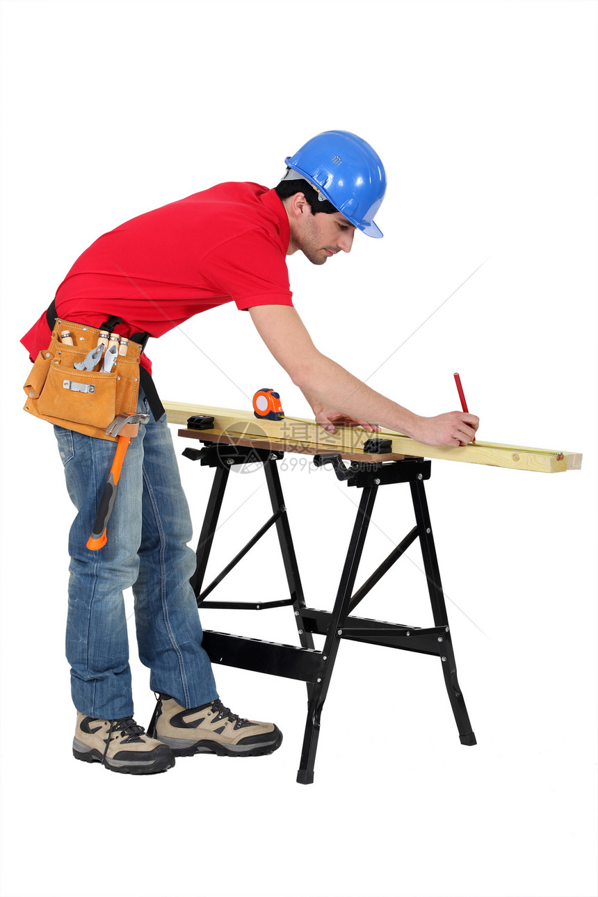 木工在一块木柴上作记号的木匠房间维修工作室木材帽子统治者职业口袋建设者铅笔图片