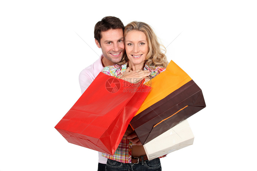 持有购物袋的夫妇商业营销经济周年男人生日购物夫妻拥抱开支图片