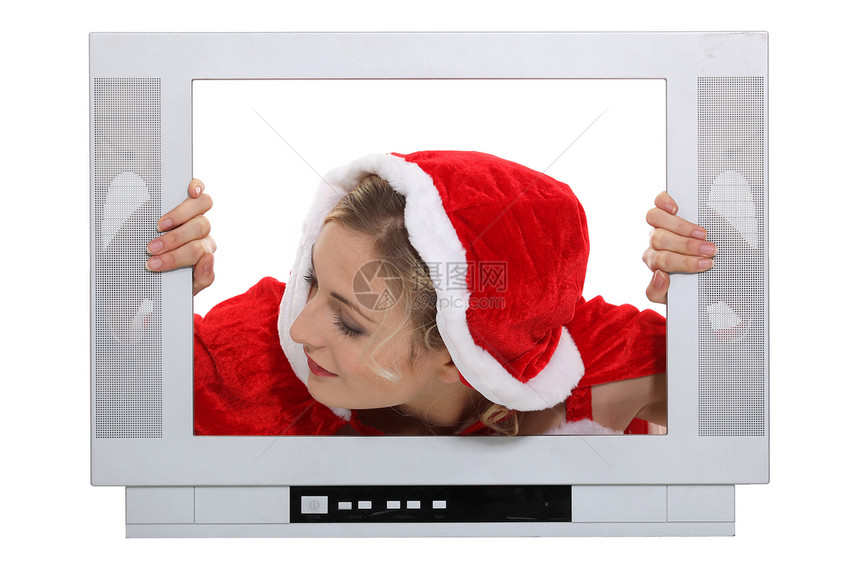 戴着圣诞帽子的女人在电视后面图片