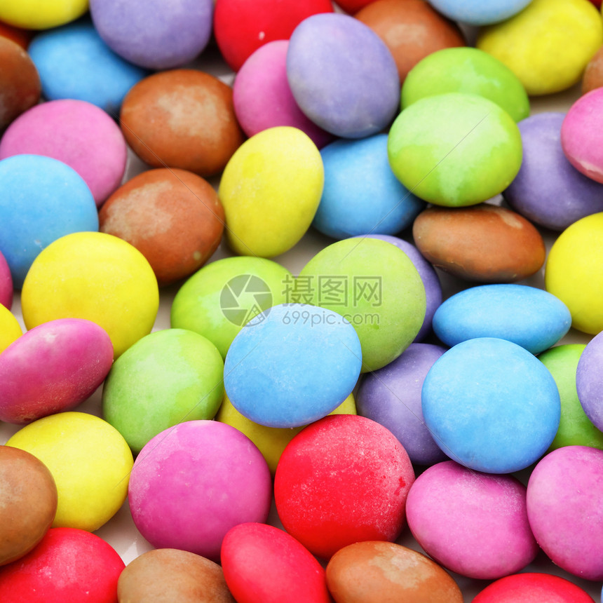 色彩多彩的糖果橙子巧克力甜点黄色团体小吃红色粉色食物绿色图片