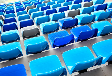 体育场的蓝色座位民众运动会场场地看台观众空白塑料长椅椅子背景图片
