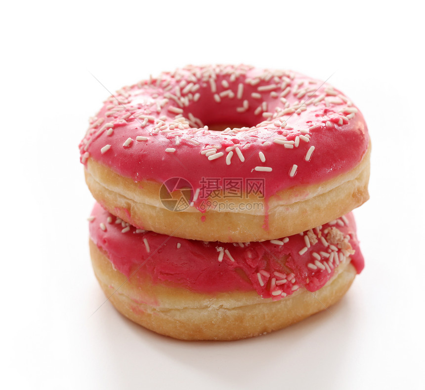 粉红色釉面的新鲜美味甜甜圈圆圈巧克力垃圾糕点早餐小吃面团磨砂蛋糕戒指图片