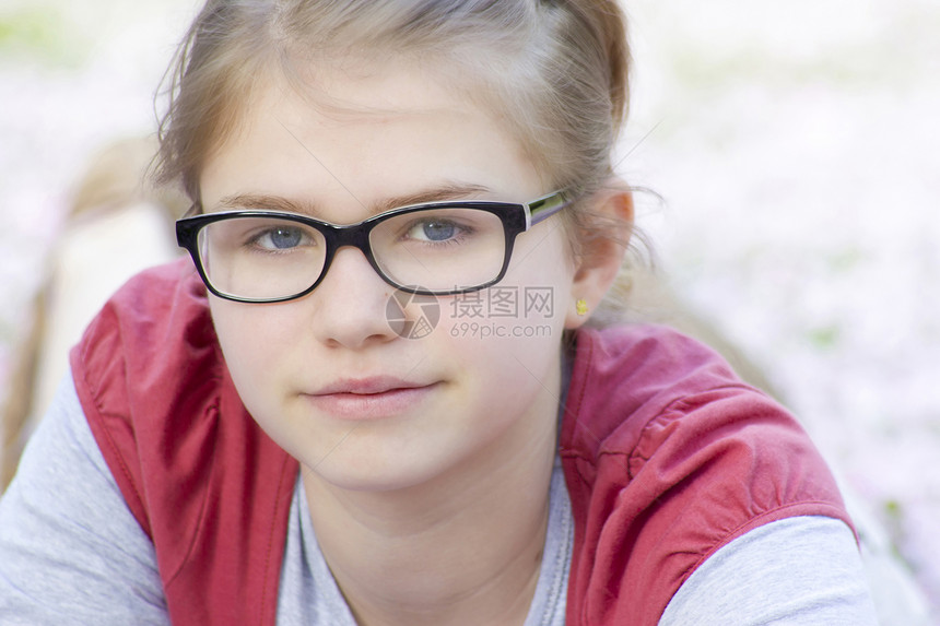 年轻女孩戴眼镜的肖像土地快乐公园活动闲暇粉色金发女郎孩子水平乡村图片
