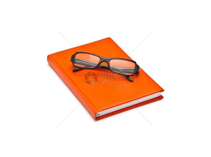 橙色书和眼镜 白底孤立于白底图片