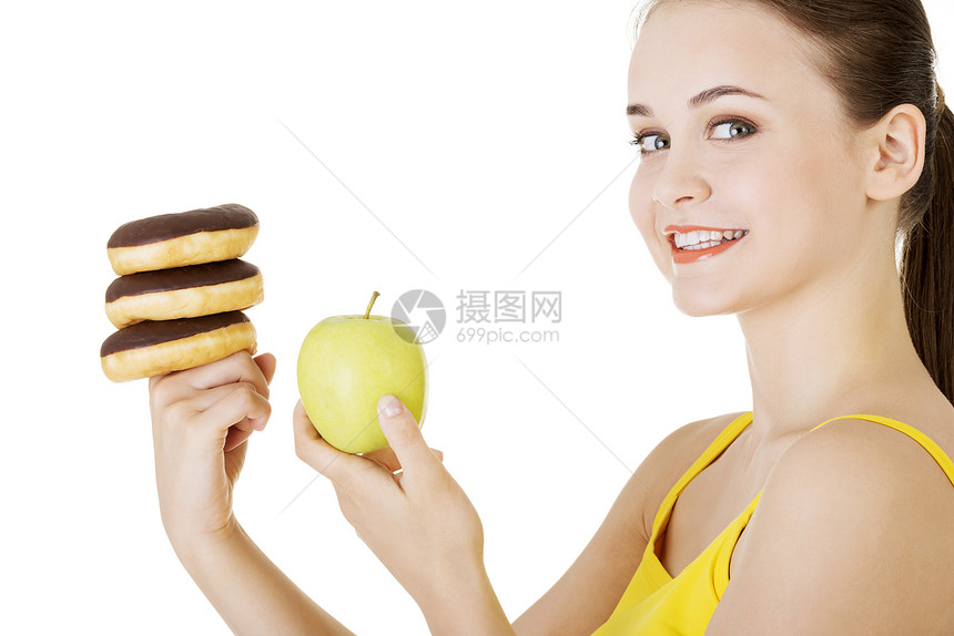 甜甜圈或绿苹果  硬选择女士思考诱惑减肥女性重量午餐女孩垃圾巧克力图片