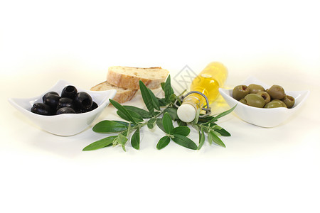 瓶橄榄油产物橄榄枝金黄色绿色食物油瓶冷压美食家背景图片