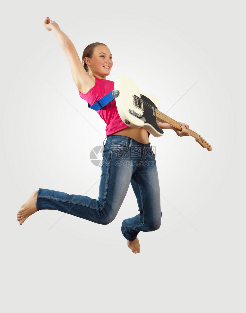 女青年玩电吉他和跳跳女士空气吉他手玩家牛仔裤行动艺术家音乐家音乐摇杆图片