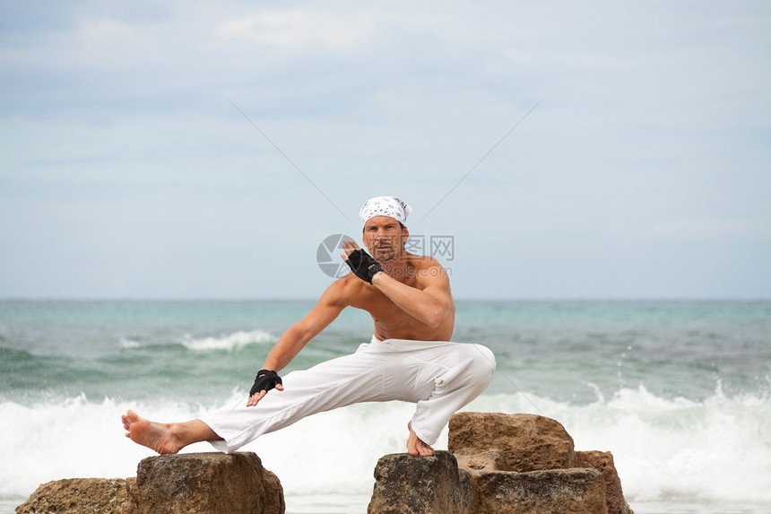 在沙滩夏天做静脉瑜伽冥想的 健康人蓝色海滩成人男人精神姿势平衡训练天空专注图片