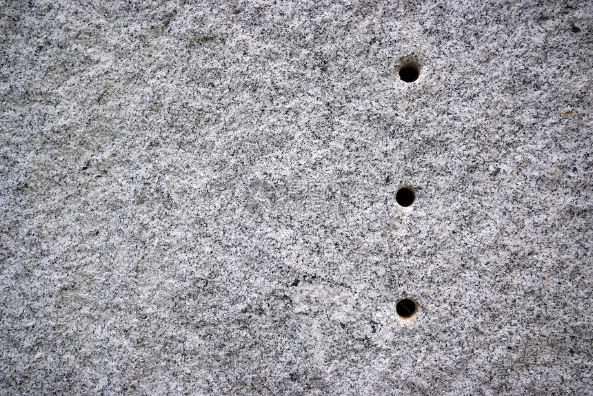 花岗岩上的圆洞石头地质学墙纸岩石建筑学圆圈材料矿物粮食宏观图片