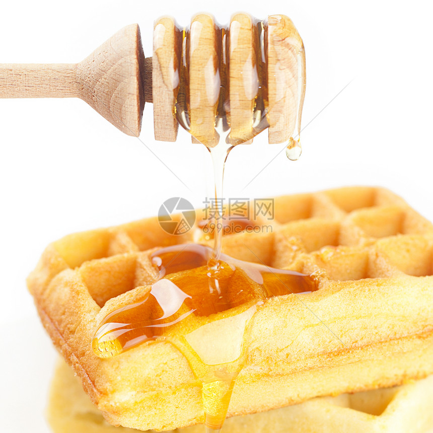 比利时的华夫饼放在盘子上 粘贴蜂蜜和蜂蜜液体棍棒蛋糕早餐糕点牛奶甜点美食食物午餐图片