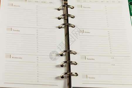 黑色笔记簿组织者对白色背法的特写图像笔记本条目议程文学商业日程规划师床单笔记数字背景图片