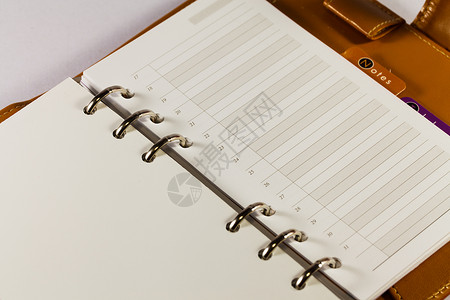 黑色笔记簿组织者对白色背法的特写图像时间床单条目商业文档调子记录选项清单日记背景图片