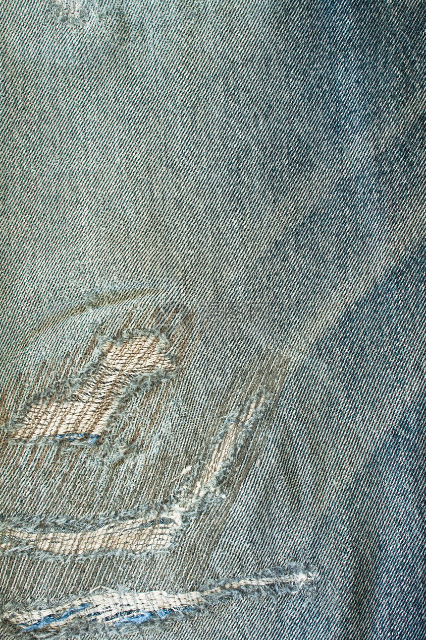撕裂的jean纹理工作服蓝色纤维织物帆布服装牛仔裤二手裤子材料图片
