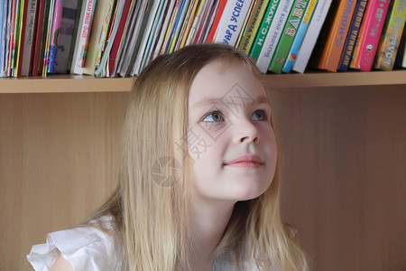 书本背景的漂亮女孩白色孩子金发童年头发背景图片