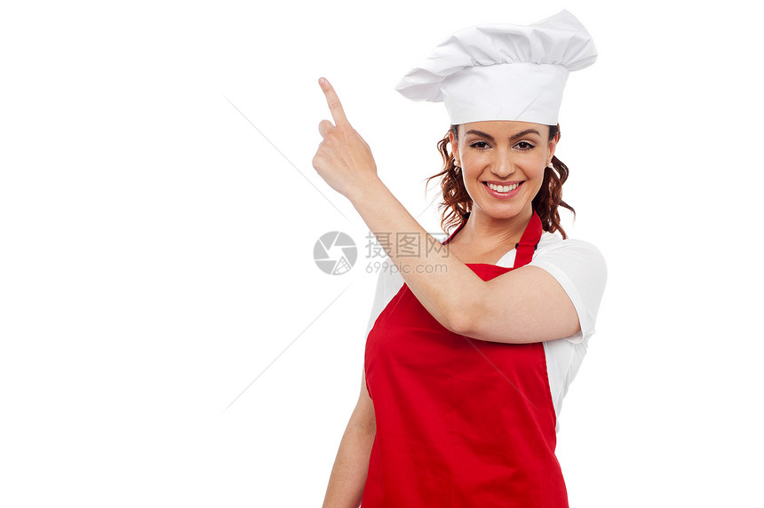 指着复制空间的有吸引力的女性厨师工作商业快乐女士餐厅餐饮厨房职业面包面包师图片