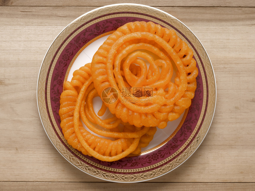 印度 Jalebi 甜食垃圾食物小吃水平藏红花糖果油炸橙子螺旋甜点图片