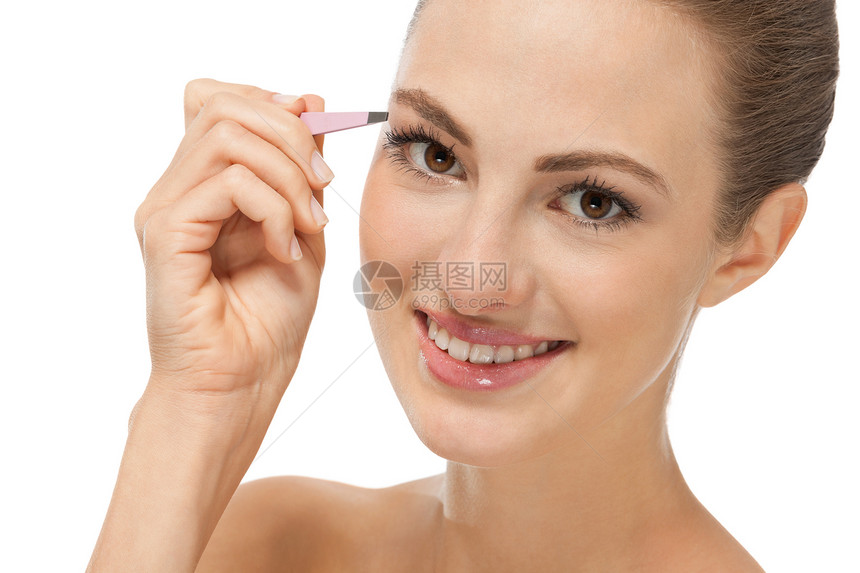 美丽的年轻美少女和眉毛卫生眼睛沙龙女性女士美容师工具化妆品眉头镊子图片