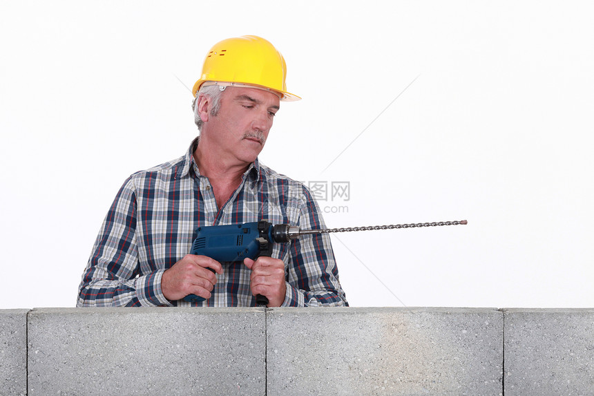 从事石工钻井的工人职业贸易工具钻头头盔项目力量建筑职员男人图片