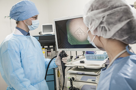 手术器材两名外科医生准备做手术 看医疗设备背景