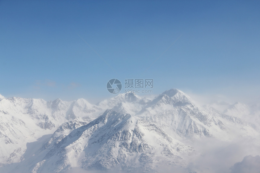 冬季山区全景冰川阳光旅行荒野运动爬坡冻结假期顶峰图片