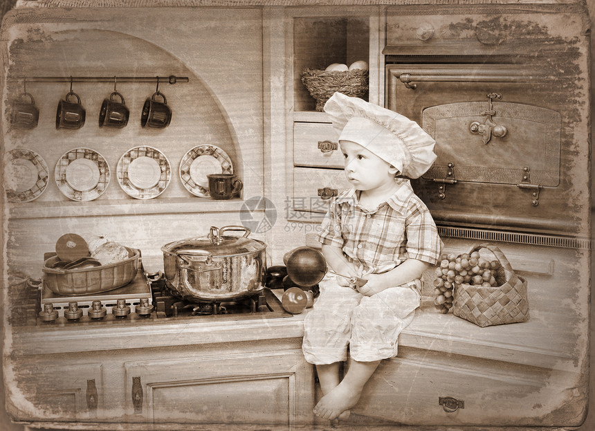 小男孩坐在厨房的桌子上图片
