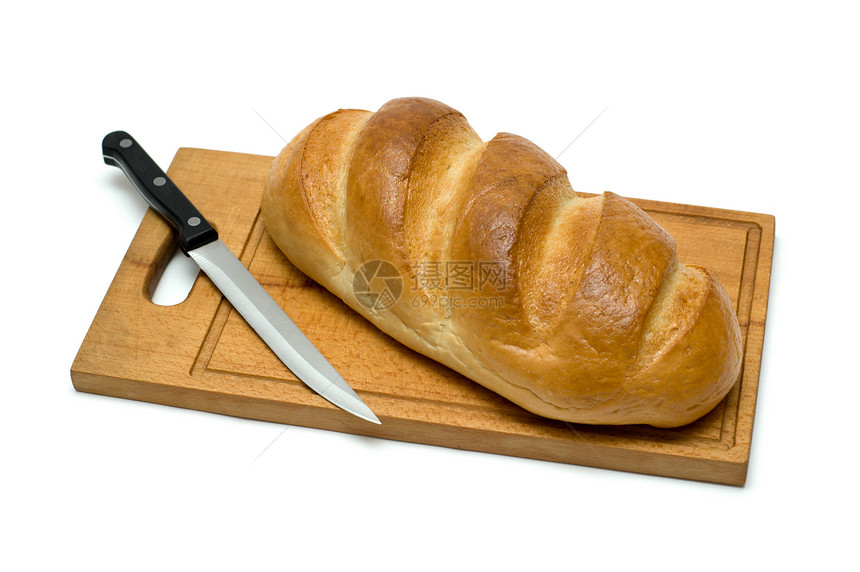 面包板上带刀子的新鲜自然面包早餐谷物烹饪食物大麦糖类甜点午餐木头饮食图片