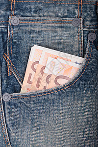 货币和牛仔裤纺织品棉布口袋材料衣服织物纤维蓝色裤子背景图片