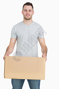 携带纸板盒的青年男子肖像微笑搬迁幸福送货员服务男人家庭生活男性快递纸板背景图片
