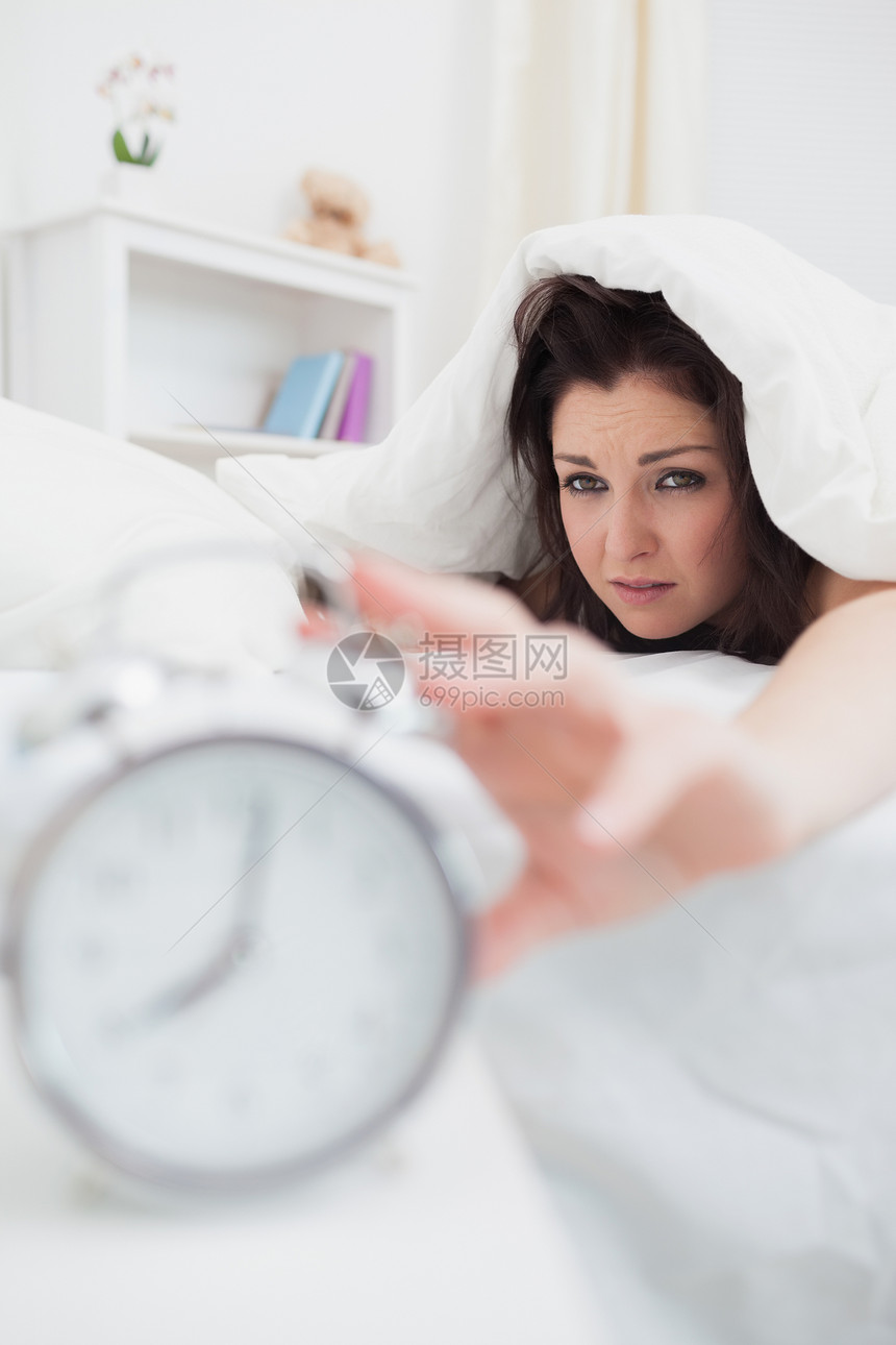 床上女人把手伸向闹钟房子休息女性系列延伸女士卧室生命家庭生活警报图片