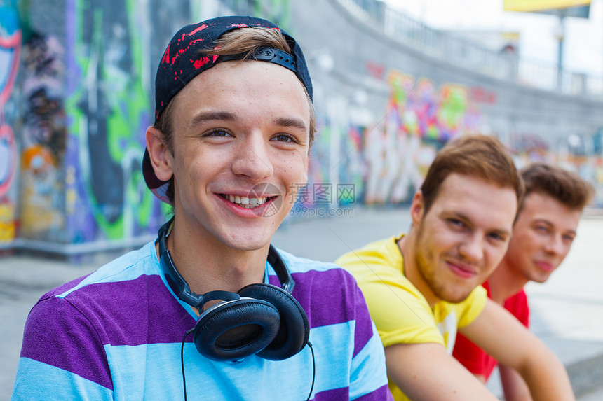 三个年轻朋友幸福快乐绘画男性滑板衣服街道青少年友谊涂鸦公司男生图片