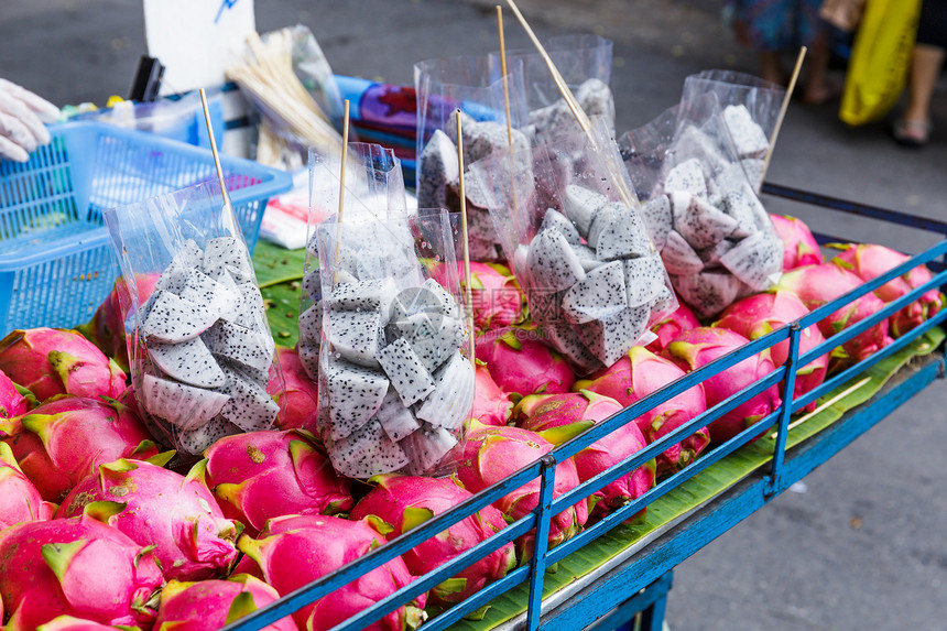 龙果在市场摊上摊位街头市场街道红色水果摊食物图片