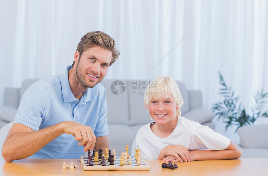 小男孩和他爸爸玩象棋图片