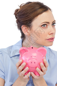 满脑子想的女商务人士在近距离内与小猪银行作假背景图片