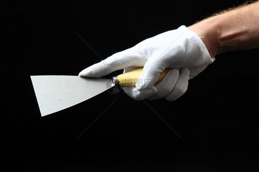 一个斯帕图拉和一只手金属维修工作乐器扳手工艺锤子工人图片