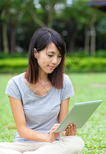 亚裔女性看电脑平板电脑背景图片