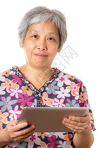 亚洲老年妇女使用数字平板电脑退休白色女人男人药片技术老人老太婆背景图片