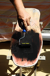 恢复旧式滑板装潢滑冰刷子装修绿色木头甲板古董滚筒孩子背景图片