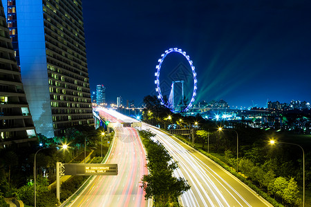 新加坡城市风景摩天大楼摩天轮城市传单红绿灯车轮轨迹天空天际交通背景图片