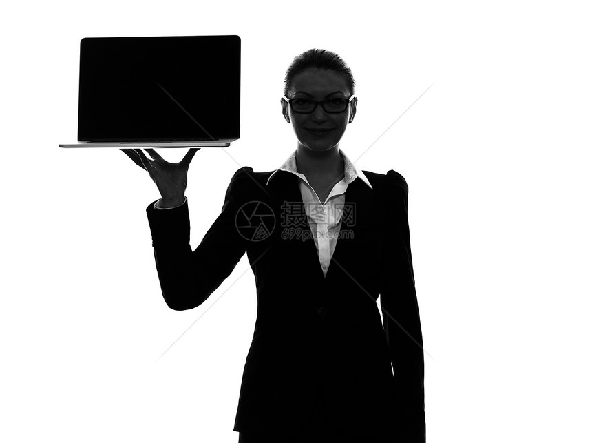 持有计算机手提笔记本电脑影带的商业妇女图片