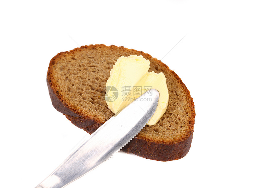棕色面包上的黄油刀粮食美食早餐午餐盘子小吃饮食奶油用具白色图片
