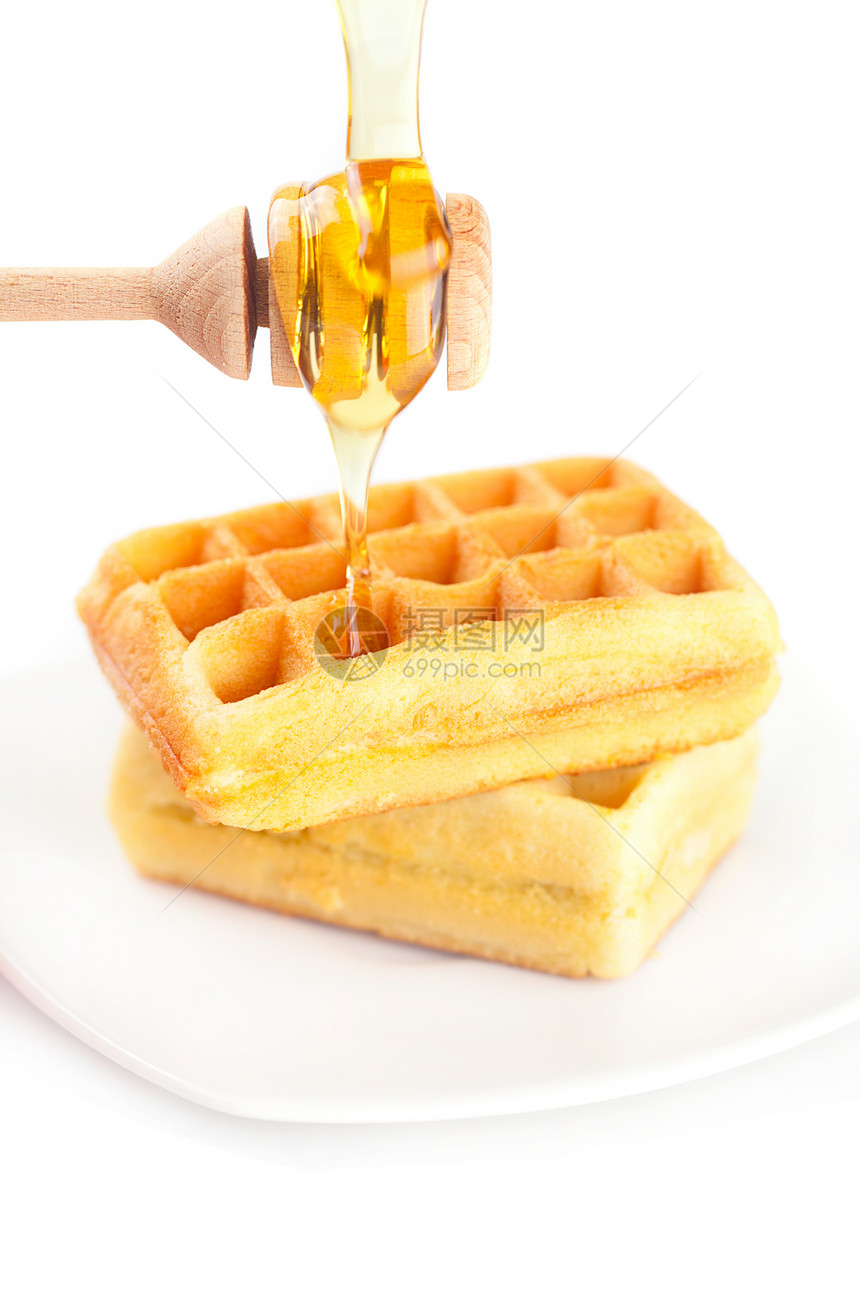 比利时的华夫饼放在盘子上 粘贴蜂蜜和蜂蜜面包早餐蛋糕美食甜点小吃棍棒食物牛奶饼干图片