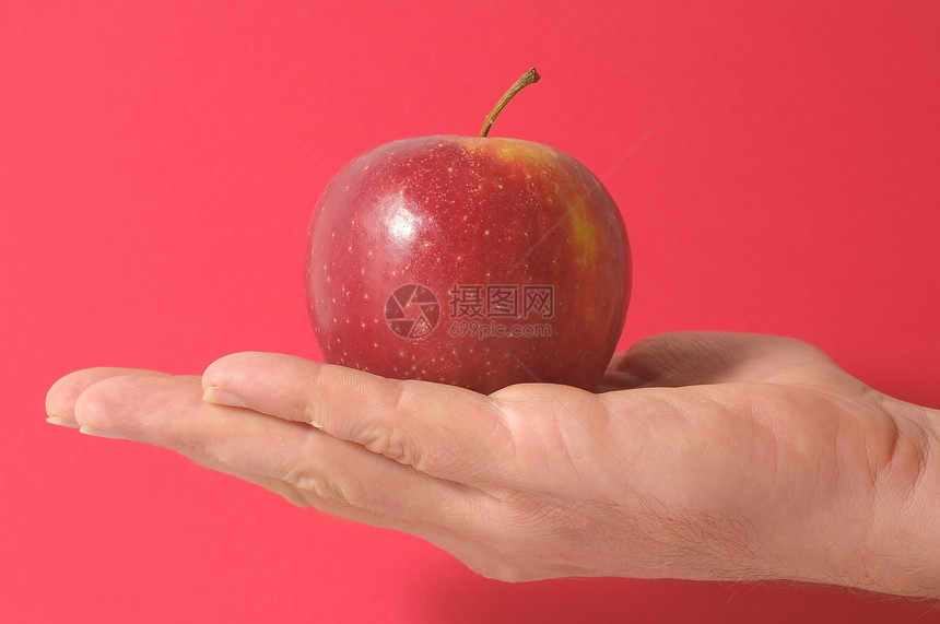 手头上的苹果水果采摘药品概念食物饮食图片