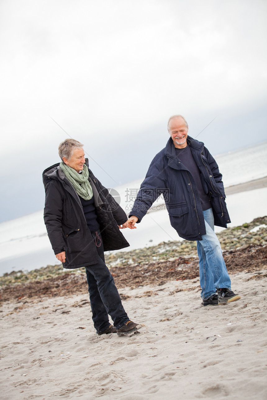 秋天在海滩散步的成熟幸福情侣退休女士女性男人妻子丈夫老年夫妻假期娱乐图片