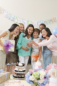 参加婴儿淋浴的妇女庆典种族女性群体幸福成人派对相机快乐蛋糕背景图片