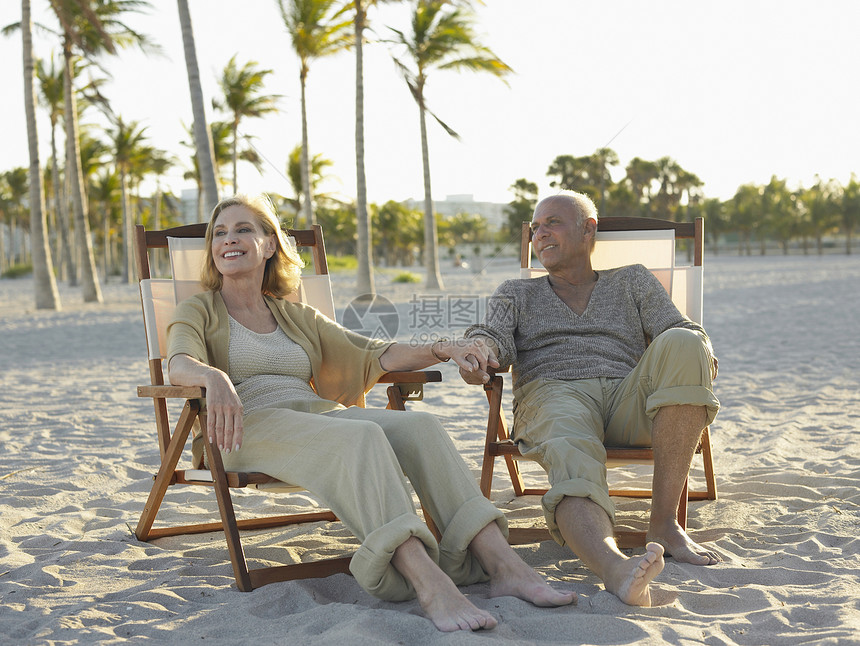 在热带海滩的甲板椅上放松 整个快乐的老年情侣婴儿关爱躺椅女性男士天空退休男人闲暇娱乐图片