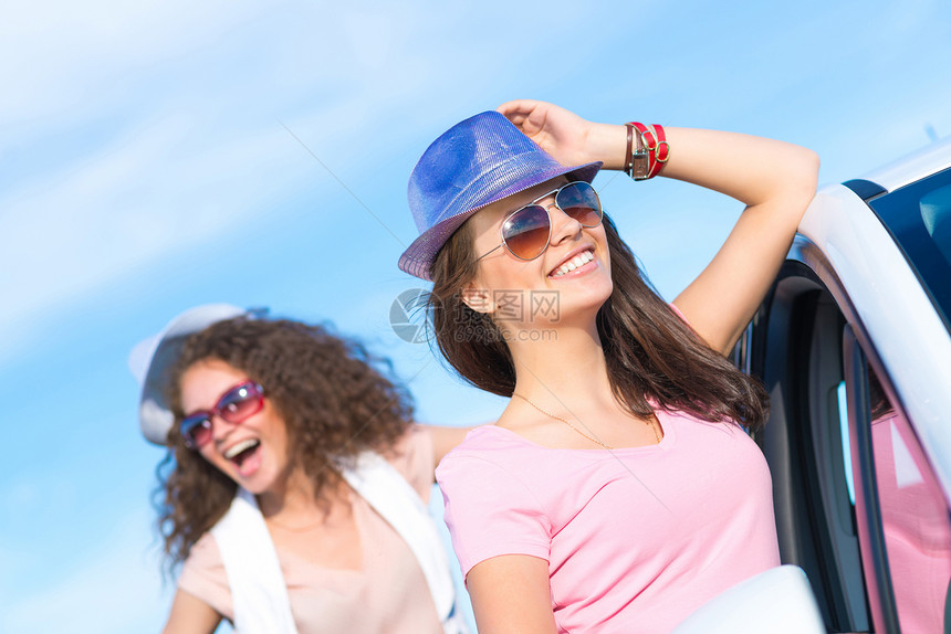 两名身戴墨镜的年轻美女闲暇微笑旅行男性天空假期家庭成人享受幸福图片
