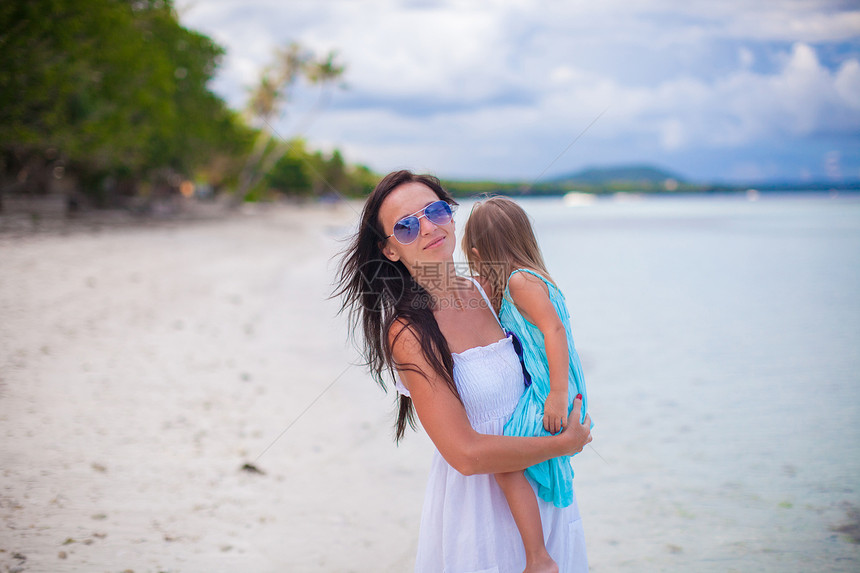 年轻母亲和女儿们享受海滩度假的年幼母亲和小女儿妈妈假期异国海滨女性家庭情调热带女士海洋图片